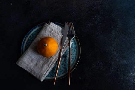 Autumnal table setting with ripe pupking for Thanksgiving holiday dinnerの写真素材