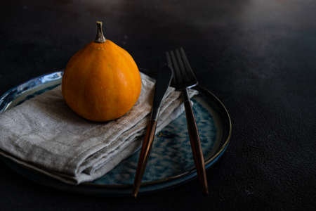 Autumnal table setting with ripe pupking for Thanksgiving holiday dinnerの写真素材