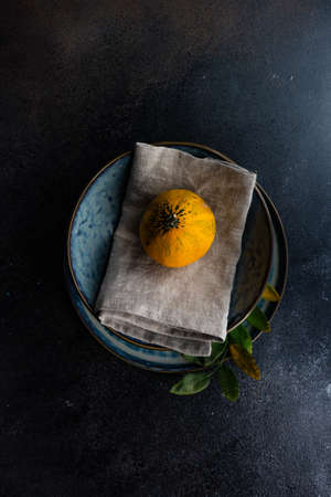 Autumnal table setting with ripe pupking for Thanksgiving holiday dinnerの写真素材