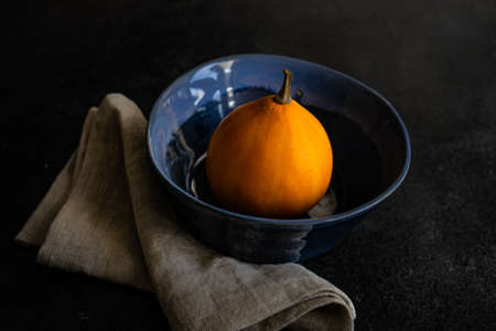 Autumnal table setting with ripe pupking for Thanksgiving holiday dinnerの写真素材