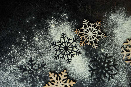 Christmas cooking concept with snowflakes cutters on stone background with copy spaceの写真素材