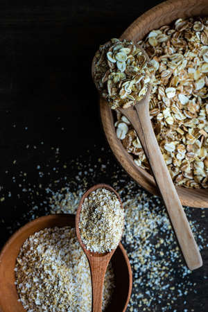 Healthy food concept with oats meal on dark rustic background with copyspace