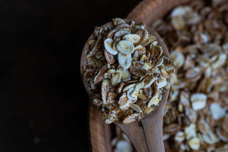 Healthy food concept with oats meal on dark rustic background with copyspace