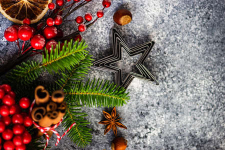 Christmas cooking background with nuts, orange, anise star and cinnamon with decor on  stone background with copy spaceの写真素材
