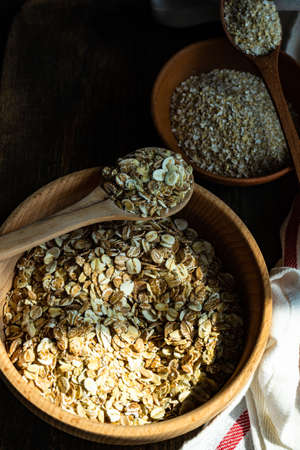 Healthy food concept with oats meal on dark rustic background with copyspaceの写真素材