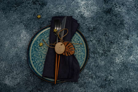 Table setting for festive Christmas dinner on stone table with copy spaceの写真素材