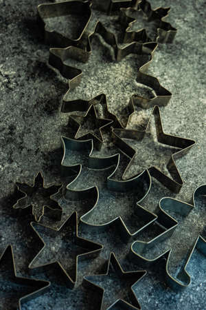 Christmas cooking concept with cookies cutters on stone background with copy spaceの写真素材