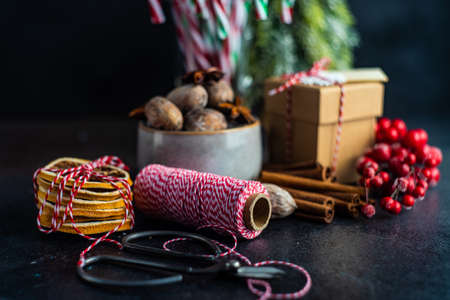 Christmas food concept with spicea like cinnamon sticks, anise star, oranges and nuts on stone background with copy spaceの写真素材