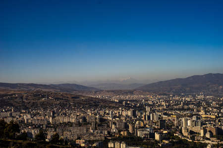Panoramic view to Tbilisi's downtown with modern areas of city centre and mount Kazbek on the city's skylineの写真素材