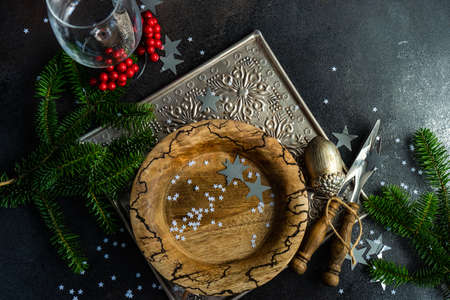 Christmas table setting with decor and cutlery on stone background with copy space