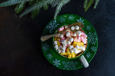 Glass with christmas cocoa drink with marshmallow on stone background with copy spaceの写真素材