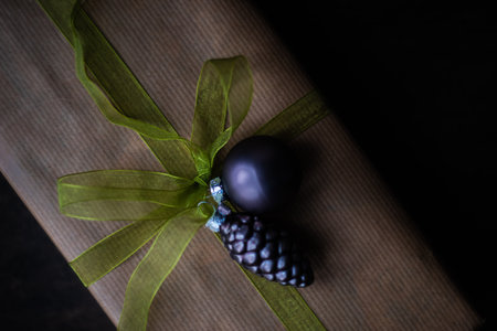 Christmas frame with gift box, holiday decor and fir tree on rustic background with copy spaceの写真素材