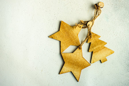 Christmas frame with wooden festive decor on white stone background with copy space