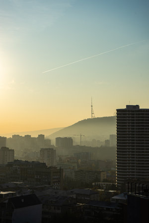 Misty autumnal sunrise over the Saburtalo area in Tbilisi city centre, Georgiaの写真素材