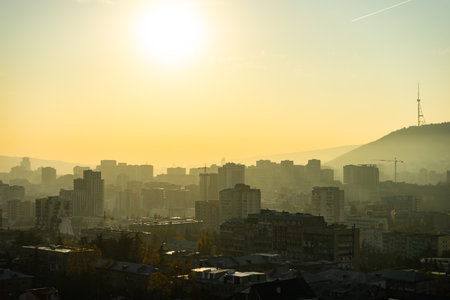 Misty autumnal sunrise over the Saburtalo area in Tbilisi city centre, Georgiaの写真素材