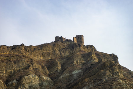 27 NOVEMBER 2019, KSANI, GEORGIA: Ruins of famous medieval castle Qsnis tsikhe on hill top over Ksani townのeditorial素材