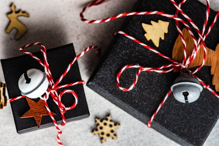 Christmas gift boxes with holiday decor on stone background with copy space