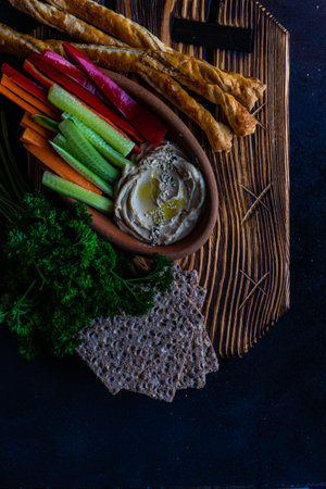 Traditional chickpeas hummus with olive oil and sesame seeds on stone background with copy spaceの写真素材