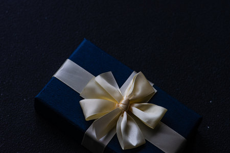 Deep blue gift box on dark background with copy spaceの写真素材
