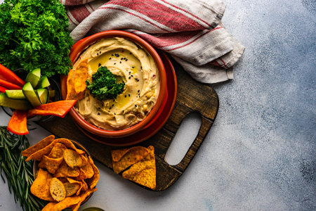 Traditional chickpeas hummus with olive oil and sesame seeds on stone background with copy spaceの写真素材