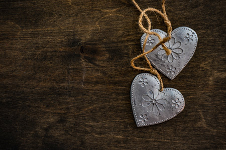 St. Valentine card concept with heart shaped decor on wooden background with copy space