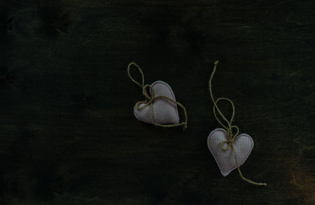 St. Valentine card concept with heart shaped decor on wooden background with copy space