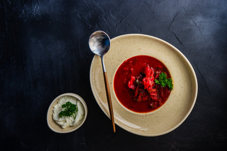 Traditional ukrainian beet soup red borscht on wooden table