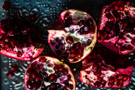 Organic food concept with fresh and ripe pomegranate on rustic background with copy spaceの写真素材
