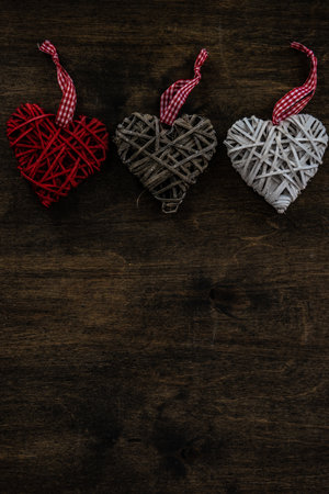 St. Valentine card concept with heart shaped decor on wooden background with copy spaceの写真素材