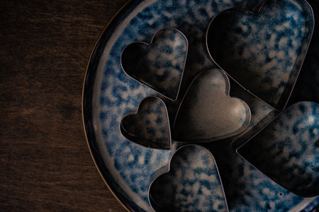 Cookies bake concept for holiday St. Valentine Day on wooden background with copy space