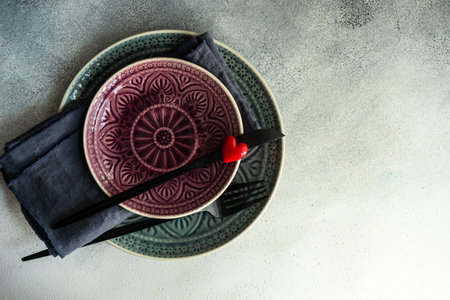 Cutlery set with hearts on stone background with copy space