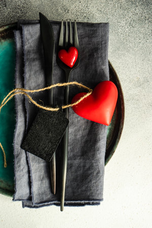Cutlery set with hearts on stone background with copy spaceの写真素材