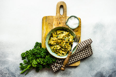 Traditional georgian summer lobio dish with  french beans with eggs and herbs on stone background with copy spaceの写真素材