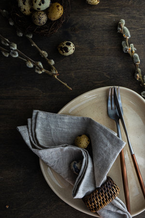 Rustic table setting for holiday Easter dinner on vintage wooden background with copy space