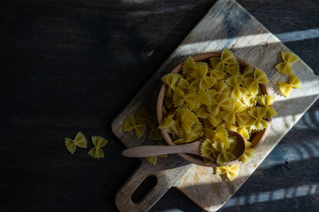 farfalle pasta in a bowl on rustic background with copy space