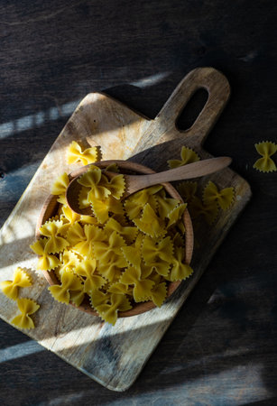 farfalle pasta in a bowl on rustic background with copy spaceの写真素材
