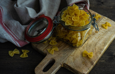 farfalle pasta in a bowl on rustic background with copy spaceの写真素材