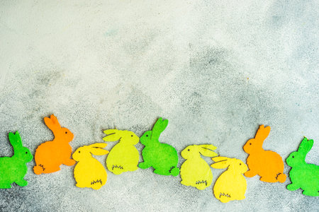 Easter holiday card concept with wooden decor in easter bunny shape on stone background with copy spaceの写真素材