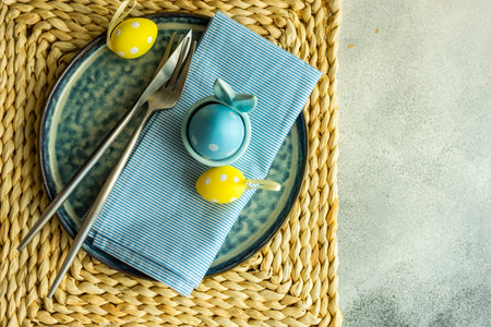 Holiday table setting for festive Easter dinner decorated with eggs