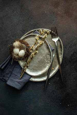 Easter festive table setting for holiday dinner on dark concrete background with copy space