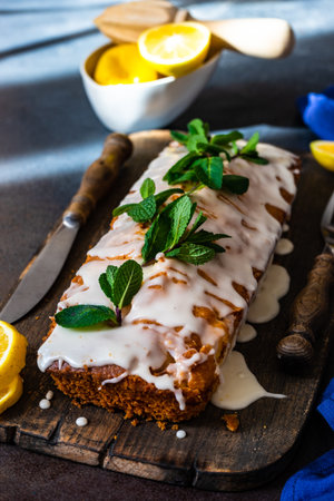 Tasty lemon cake with fresh mint on stone background with copy space