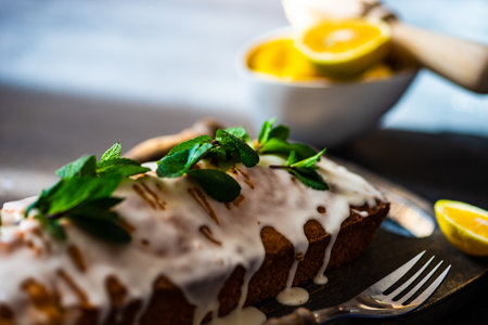 Tasty lemon cake with fresh mint on stone background with copy spaceの写真素材