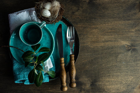 Easter table setting with eggs on wooden background with copy space