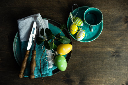 Easter table setting with eggs on wooden background with copy space