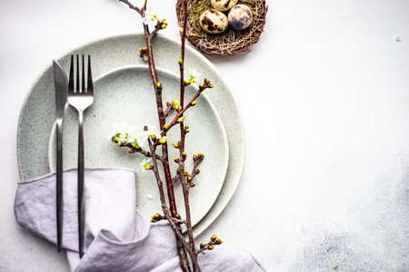 Spring floral table setting for Easter dinner on rustic background with copy space