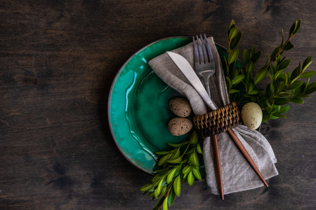Spring floral table setting for Easter dinner on rustic background with copy spaceの写真素材