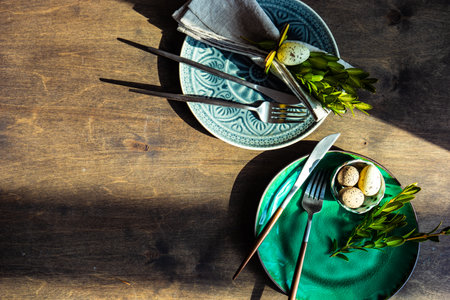 Spring floral table setting for Easter dinner on rustic background with copy space