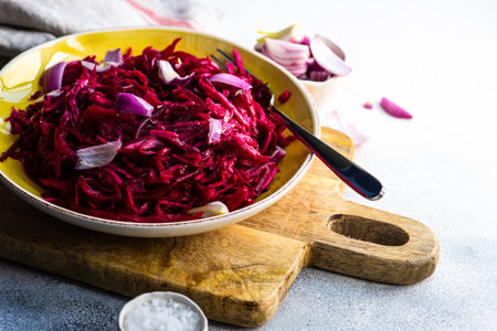 Homemade fermented food with cabbage and beetroot salad on stone background with copy spaceの写真素材