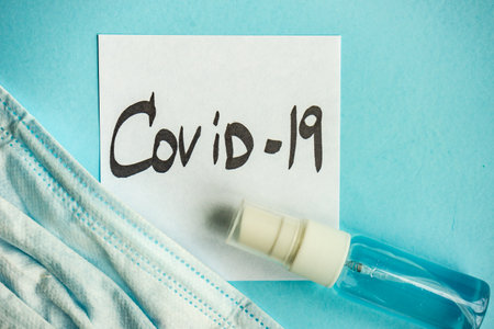 COVID-19 virus concept with face mask on pastel background with copy spaceの写真素材