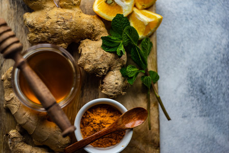 Ingredients for energy drink helping stay healthy with ginger, lemon, mint and turmericの写真素材